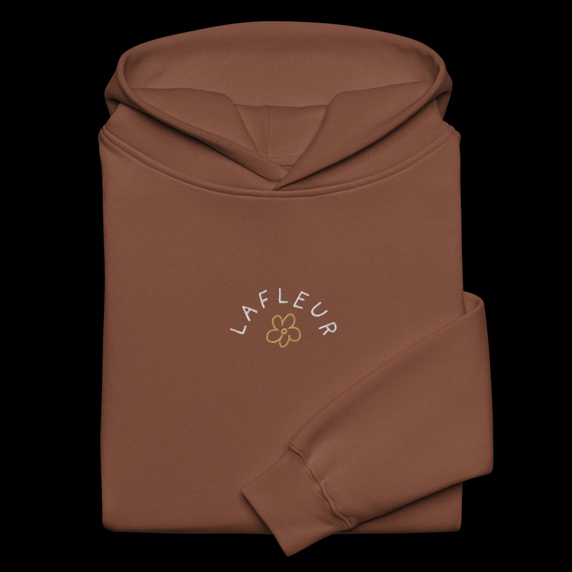 Close-up of white and gold Vestigio embroidery on chestnut hoodie
